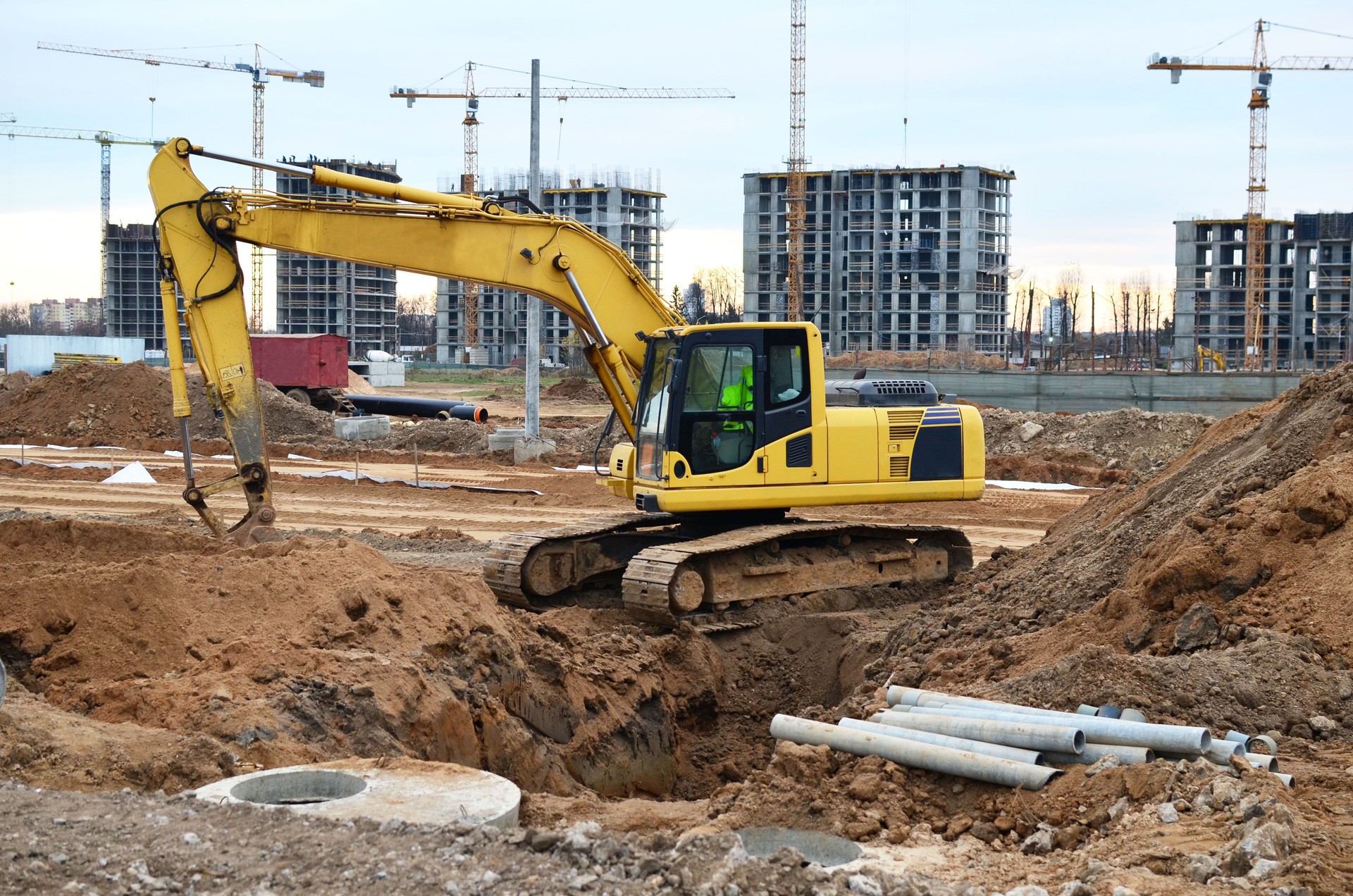 Excavator digs the ground for the foundation and construction of a new building